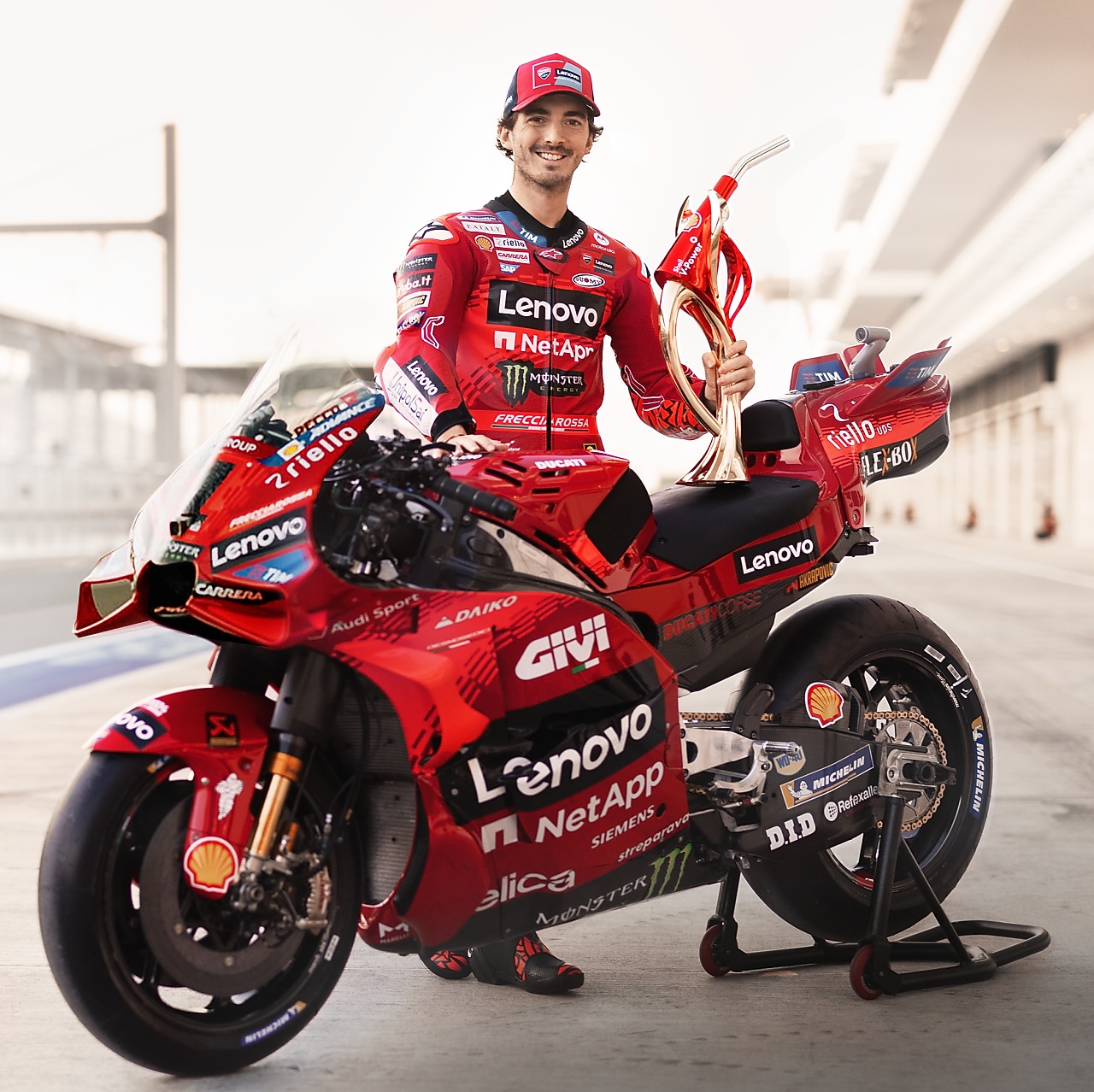 Ducati Corse team leaning on Ducati Motorbike.